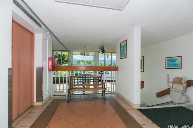 corridor featuring a healthy amount of sunlight, tile patterned flooring, floor to ceiling windows, and baseboards