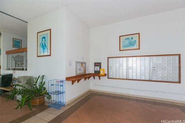 corridor with tile patterned flooring and baseboards