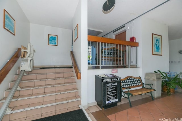 stairway featuring tile patterned flooring