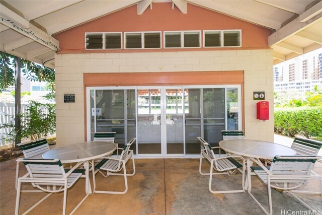 view of patio with outdoor dining space and fence