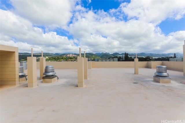 view of patio featuring fence and a mountain view