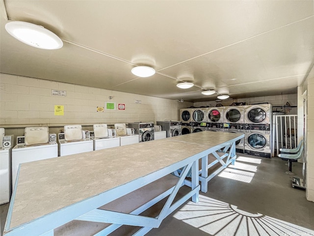 1016 Ehoeho Ave Unit 208, Wahiawa, HI 96786 - community laundry featuring stacked washer / drying machine, concrete block wall, and washing machine and clothes dryer