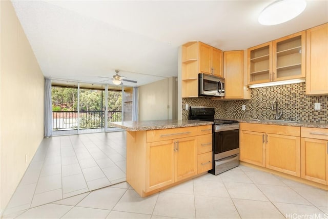 kitchen featuring floor to ceiling windows, open shelves, stainless steel appliances, tasteful backsplash, and a peninsula