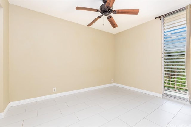 spare room featuring ceiling fan and baseboards