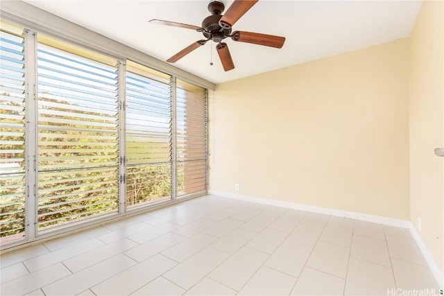 unfurnished room with ceiling fan and baseboards