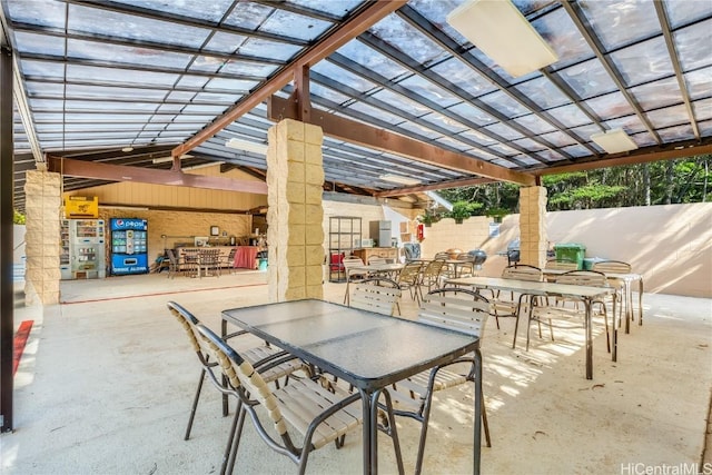 view of patio featuring outdoor dining space, fence, and a pergola