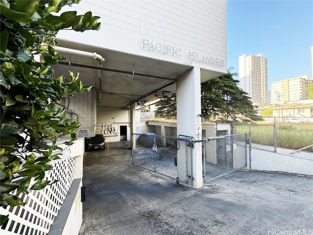 view of patio featuring a gate, a city view, and fence