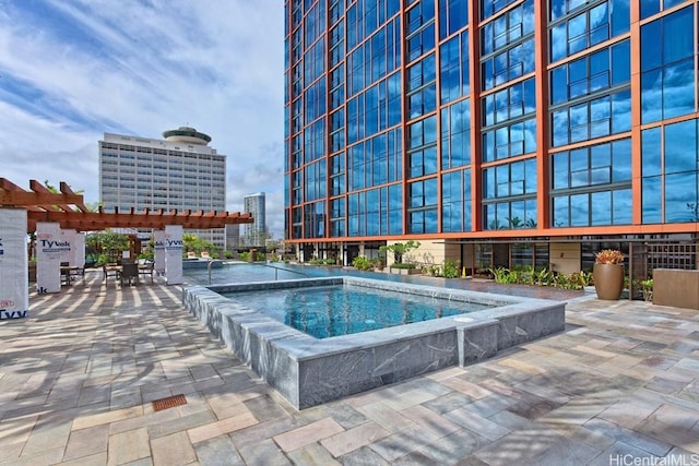 view of swimming pool with a city view