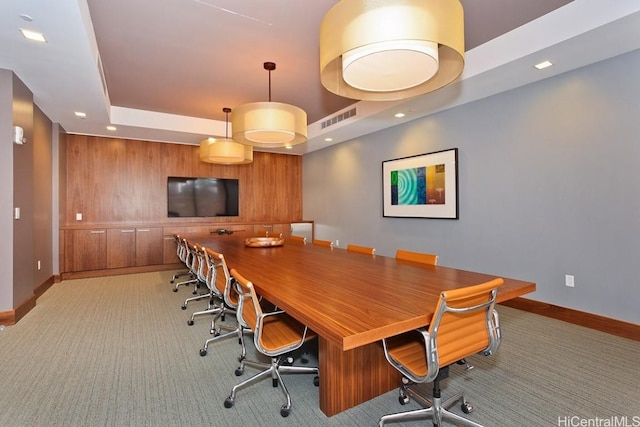 carpeted office space featuring recessed lighting, visible vents, a raised ceiling, and baseboards