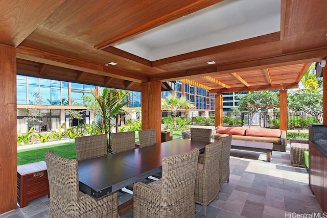 view of patio with outdoor dining space and fence