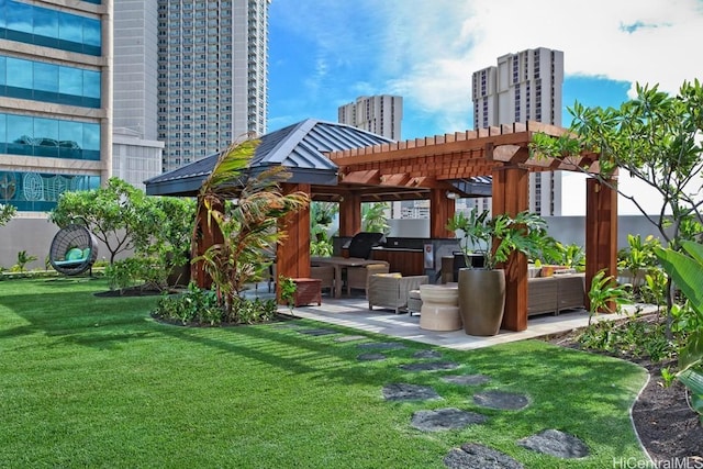 exterior space featuring a patio area, a view of city, a pergola, and exterior kitchen