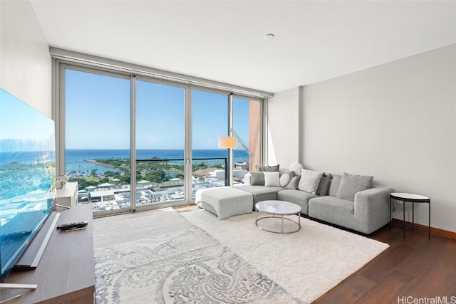 living room with dark wood-style flooring, a water view, baseboards, and expansive windows