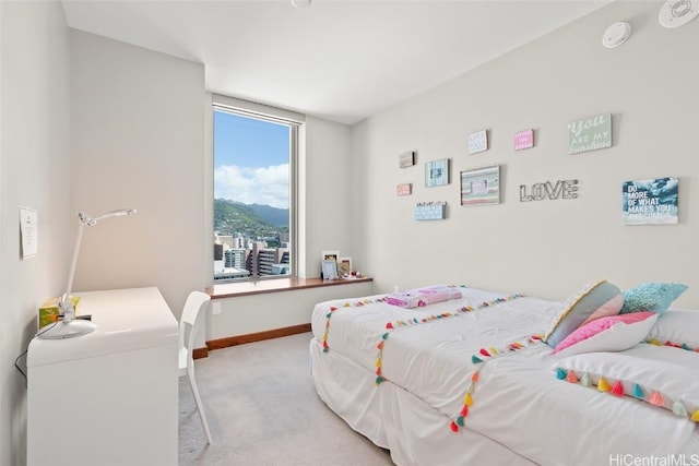 bedroom with a mountain view, baseboards, and carpet