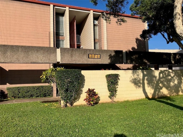 view of property exterior featuring fence and a yard