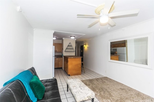 unfurnished living room featuring light tile patterned flooring and ceiling fan