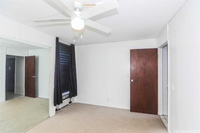 spare room featuring a ceiling fan and light carpet