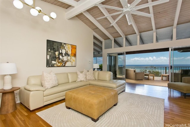 living room featuring beamed ceiling, a water view, a ceiling fan, and wood finished floors