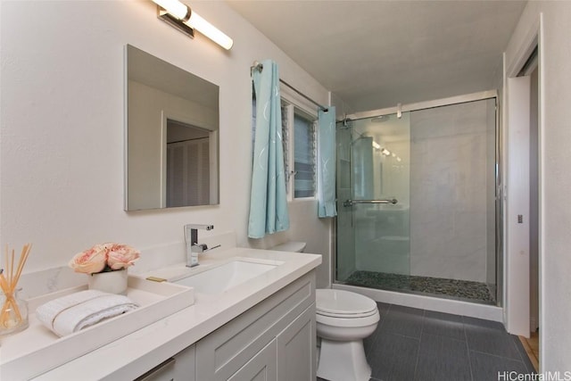 full bath with tile patterned floors, toilet, a stall shower, and vanity