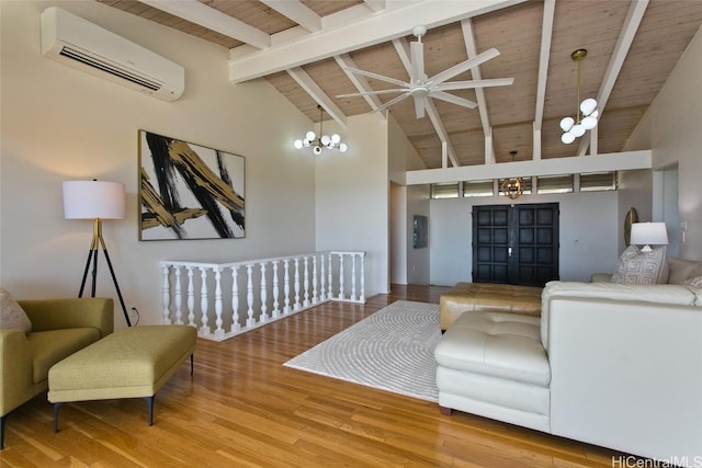 living room featuring beam ceiling, wooden ceiling, a wall unit AC, and wood finished floors