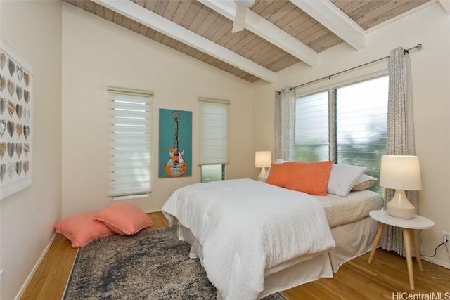 bedroom with wooden ceiling, vaulted ceiling with beams, wood finished floors, and baseboards