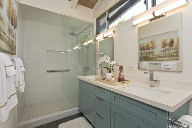 bathroom featuring a sink, walk in shower, double vanity, and tile patterned floors