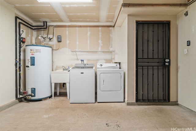 clothes washing area featuring washer and dryer, electric water heater, laundry area, and a sink