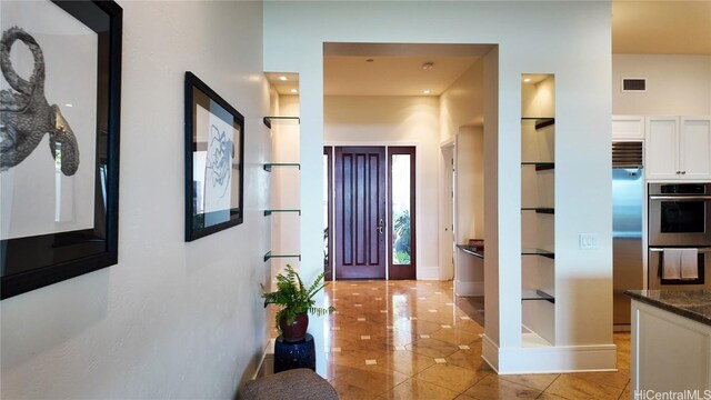 foyer with light tile patterned floors and visible vents