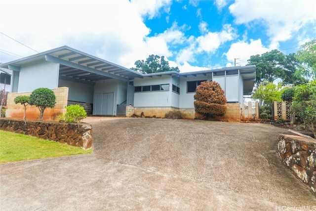 view of front of home featuring driveway and an attached carport