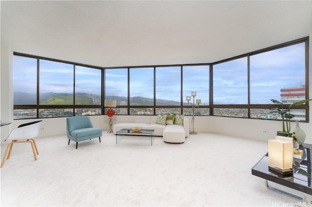 living room with carpet and a mountain view