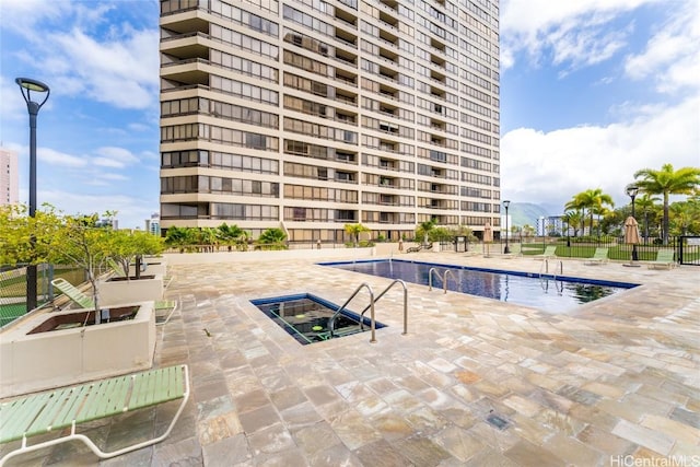 pool featuring fence and a patio