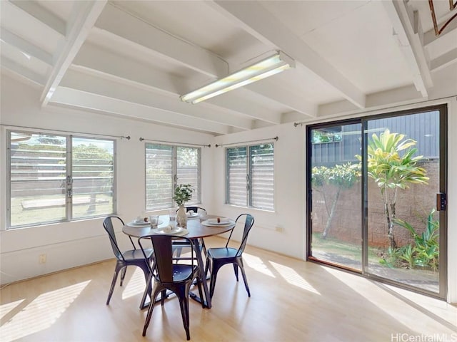 sunroom / solarium featuring beam ceiling