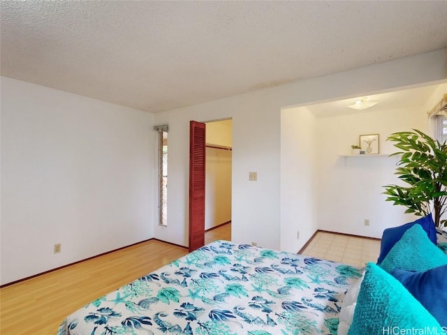 bedroom featuring baseboards and a textured ceiling