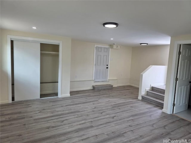 foyer featuring baseboards, stairway, wood finished floors, and recessed lighting