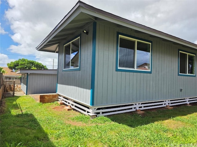 view of side of property featuring a yard and fence