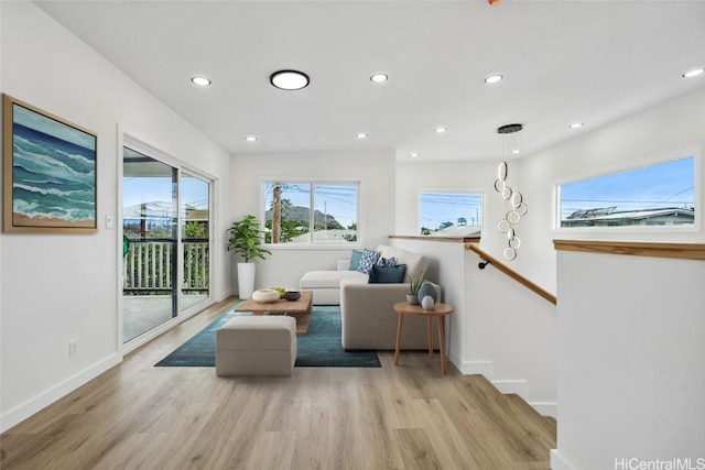 sitting room featuring baseboards, wood finished floors, an upstairs landing, and recessed lighting