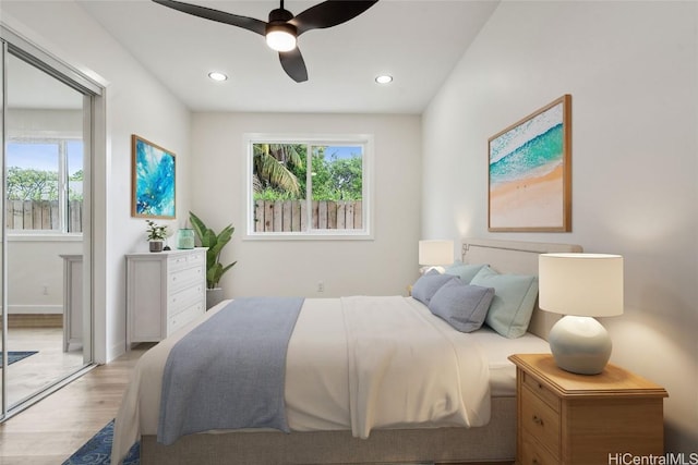 bedroom with multiple windows, light wood-type flooring, and recessed lighting