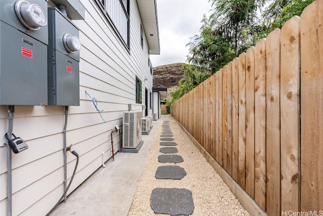 view of home's exterior featuring ac unit and fence