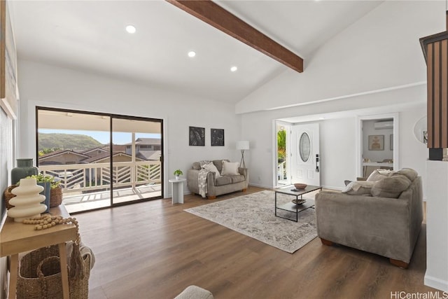 living area with high vaulted ceiling, plenty of natural light, wood finished floors, and beam ceiling