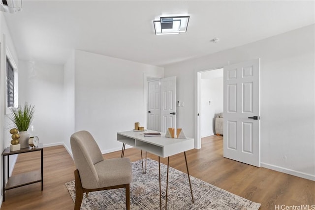 office with wood finished floors and baseboards