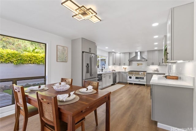 dining area featuring wood finished floors and recessed lighting