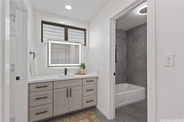 bathroom with vanity, baseboards, and shower / bathtub combination