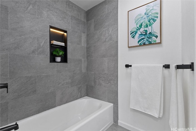 full bathroom with a tub to relax in and baseboards