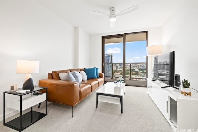 carpeted living room with floor to ceiling windows and ceiling fan