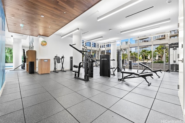 exercise room with expansive windows and wooden ceiling