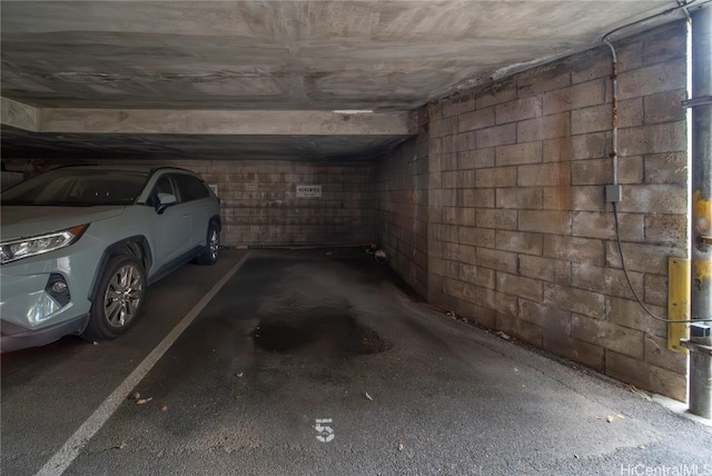 parking garage featuring concrete block wall