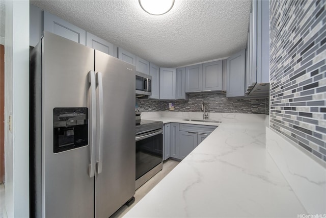 502 Captain Cook Ave Unit 201, Honolulu, HI 96813 - kitchen featuring stainless steel appliances, a sink, gray cabinets, backsplash, and light stone countertops