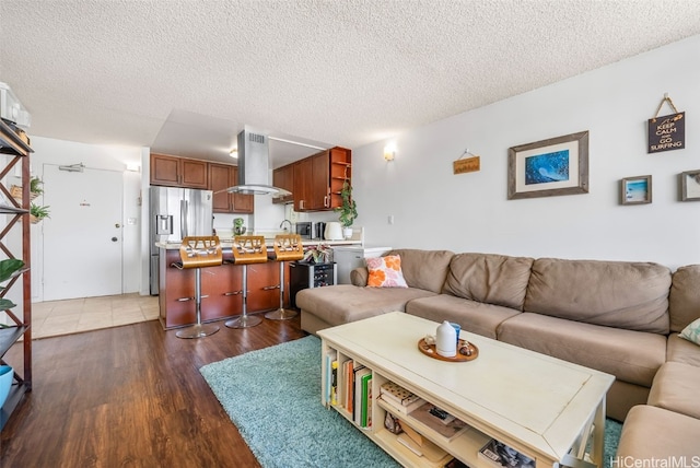 living area featuring a textured ceiling and wood finished floors