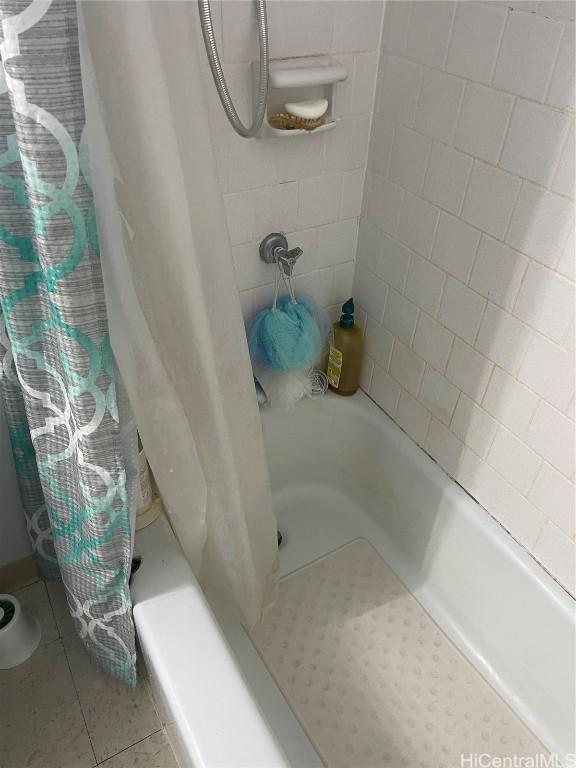 full bathroom with shower / bath combo and tile patterned floors