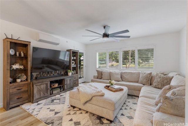 living area with a ceiling fan, wood finished floors, and a wall mounted air conditioner