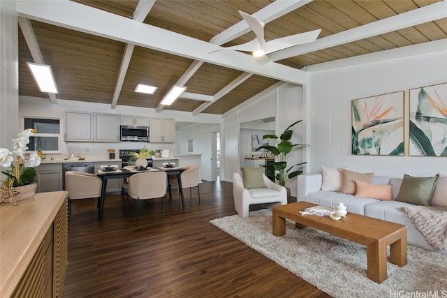 living area with vaulted ceiling with beams, dark wood finished floors, and wood ceiling